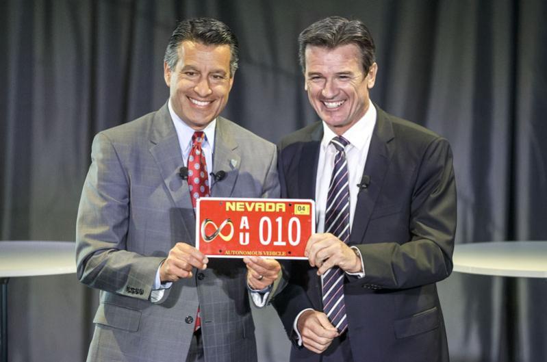 Brian Sandoval, Governor of Nevada, and Dr. Wolfgang Bernhard, member of the Daimler AG board responsible for Trucks and Buses, take first autonomous drive on a U.S. highway near Las Vegas.